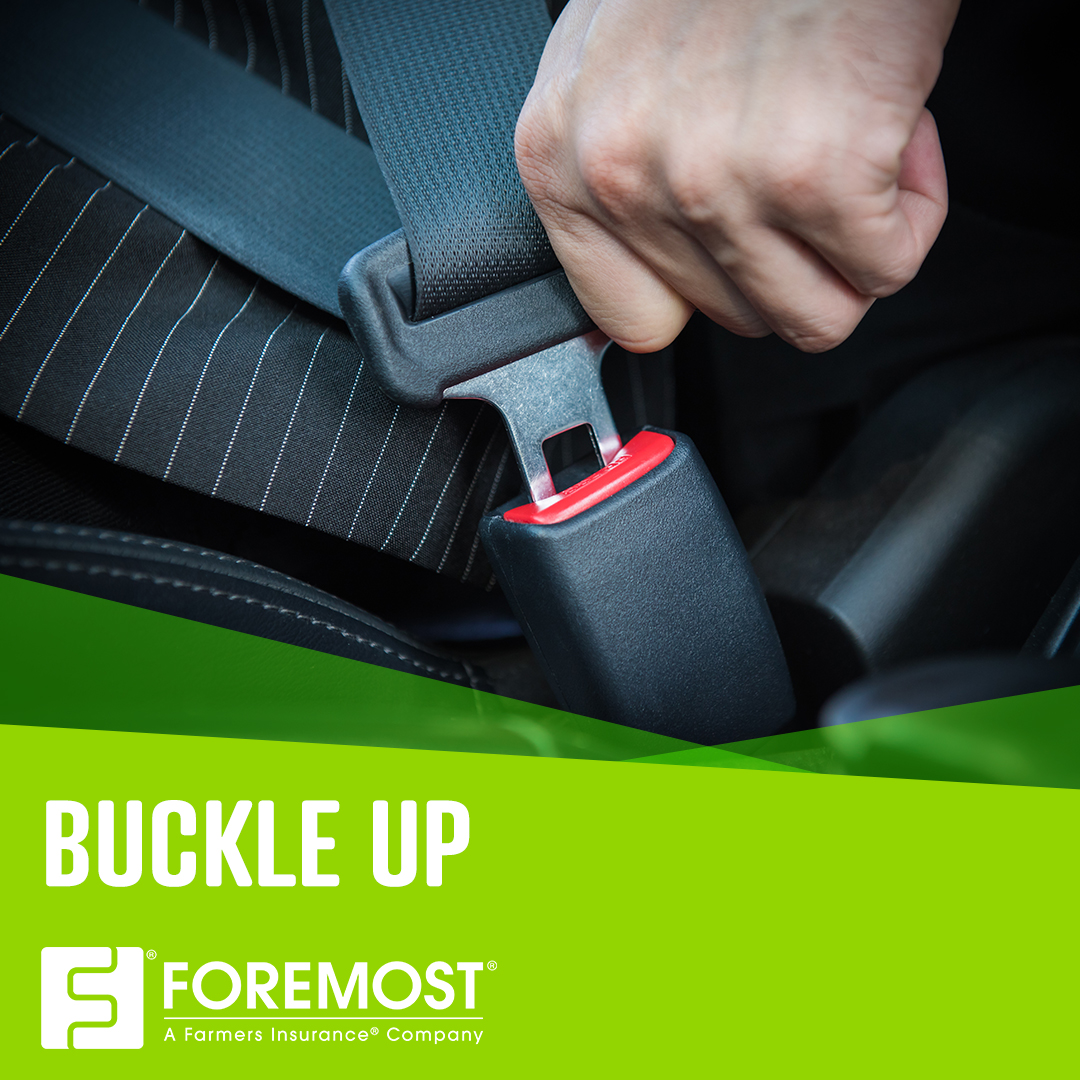 A person’s hand on a seatbelt buckle