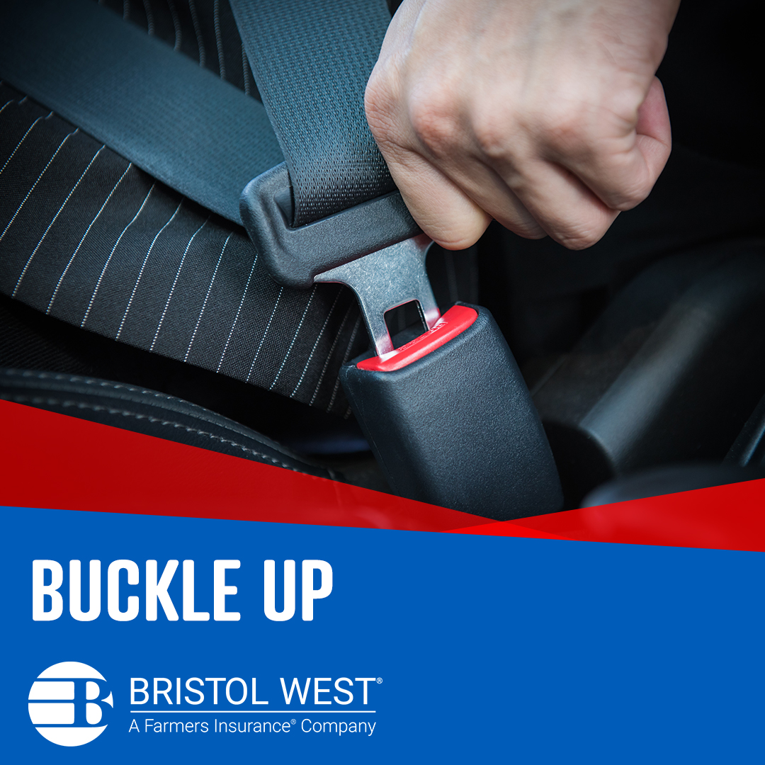 A person’s hand on a seatbelt buckle